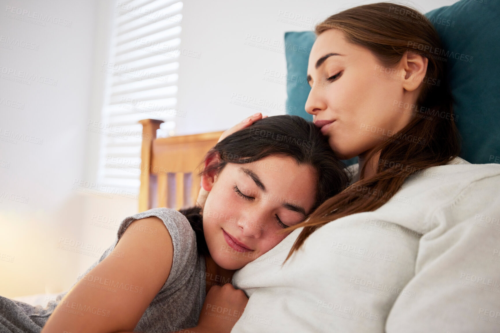 Buy stock photo Mom, sleeping and relax with daughter on bed for rest, break or bonding weekend together at home. Mother, young child or teenager asleep in bedroom with hug for comfort, childhood or embrace at house