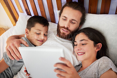 Buy stock photo Tablet, bed and father relax with children, education or learning together in family home. Digital technology, happy kids and dad in bedroom, streaming movie or reading ebook on internet with parent