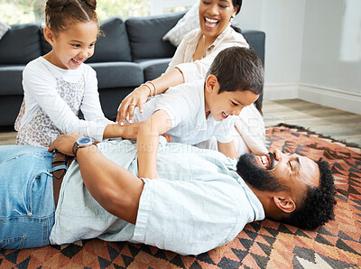 Buy stock photo Parents, children and happy in home with game, tickling fun and bonding on weekend. Couple, kids and excited family on living room floor for relationship development, Fathers Day and playful energy