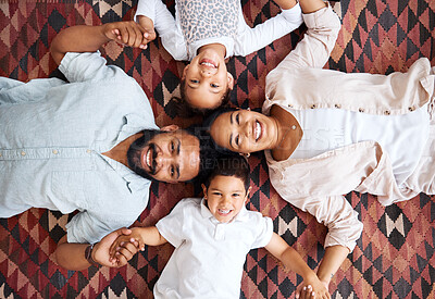 Buy stock photo Top view, holding hands and happy family with portrait in home for love, bonding or security. Smile, parents and kids siblings on living room floor with support, protection and relationship in Mexico