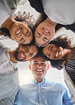 Group of joyful diverse businesspeople huddling together in support and unity together at work. Happy business professionals joining their heads in a meeting