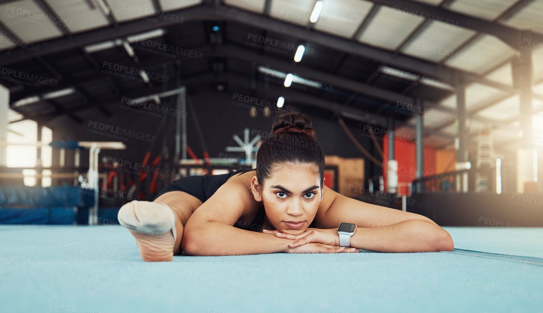 Buy stock photo Woman stretching on floor at health gym, doing workout exercise at sports club and training for fitness. Portrait of an athlete or gymnast doing gymnastics on floor, yoga for wellness and body