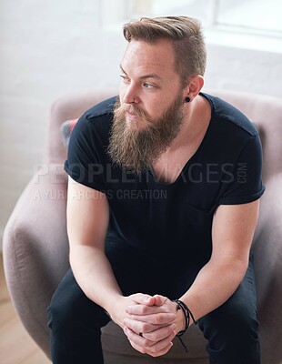 Buy stock photo Young hipster man with beard sitting looking out window contemplating