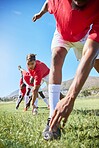 Soccer team, stretching and training for game, for practice and exercise for health, wellness or outdoor on field. Football, healthy players or focus to prepare on match day in sportswear for fitness