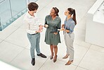 Top view, tablet and business people in office lobby discussing project, idea or online planning. Teamwork, diversity or employees in corridor working together on tech, research or web surfing online