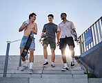 friends, walking with skateboard together in city outdoors for fun, laugh and conversation support. Diversity, young gen z men talking and sport fitness lifestyle or urban trendy street fashion