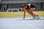 Running, sports and fitness with an asian woman athlete on a track for a race, marathon or endurance training. Health, workout and exercise with a female runner at the start of a competitive sport