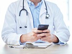 Chat, email and doctor hands with a phone for online consulting, communication and internet research. Healthcare, search and medical employee typing on a mobile for work in health and medicine