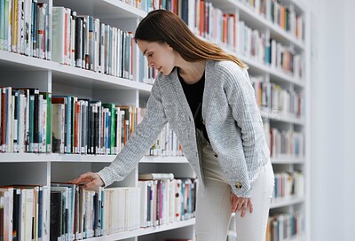 Buy stock photo Woman in library, student with book choice and research project, reading with education and learning at university campus. Knowledge, story and fiction with textbook, study and search bookshelf