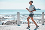 Fitness, running and man by ocean for exercise, marathon training and endurance workout in action. Sports, motivation and male runner with focus for wellness, healthy body and performance in Miami