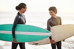 Surfing, sports and friends on the beach together during summer for training, fun or recreation. Surfboard, water or workout with a man and woman surfer standing in the ocean for exercise or leisure