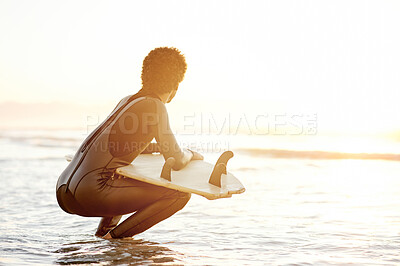 Buy stock photo Sunset, view and man with a surfboard at the beach for surfing, hobby and summer activity. Relax, calm and a surfer in the water waiting for waves, ready for practice and looking at the ocean
