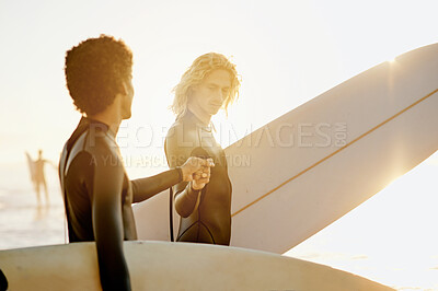Buy stock photo Fist bump, surfer and friends by the sea with lens flare ready for water sport in the ocean. Beach, men and motivation hand gesture of young people with a surfboard about to to start surfing
