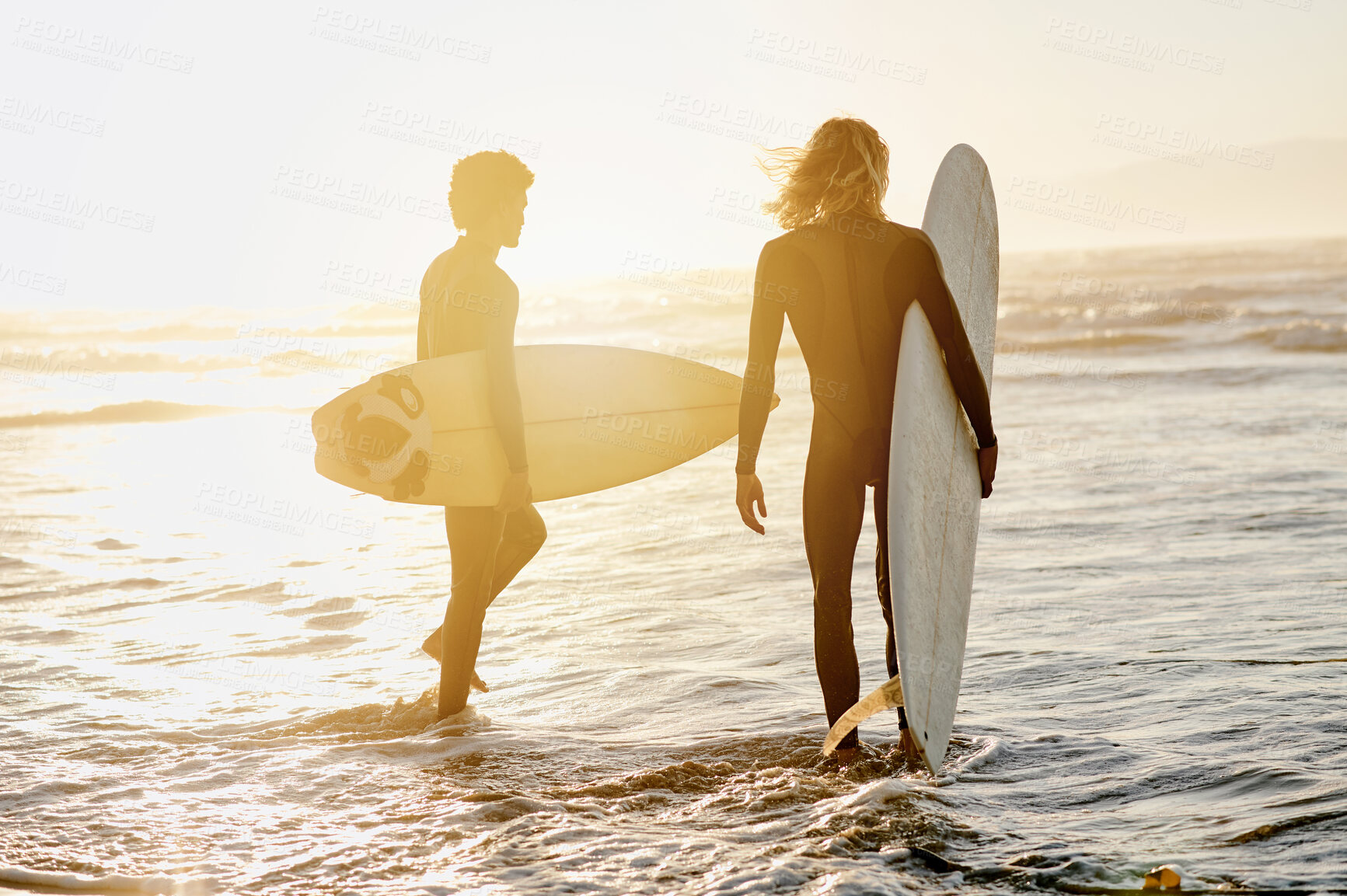Buy stock photo Back view, men and surfing friends at sunset beach for waves, freedom and swimming. Silhouette of surfer guys with board at sea, sunshine and adventure on holiday, travel and water sports in summer 
