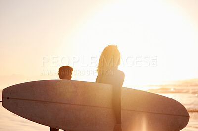 Buy stock photo Silhouette, sunrise or sunset with surfer couple at the beach, sea or ocean in the morning as exercise or workout. Surfboard, water sport and healthy people on holiday or vacation surfing together