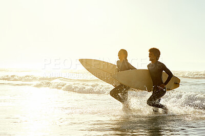 Buy stock photo Travel, sunset and couple running on the beach with surfboards to practice surfing while on vacation. Nature, sports and young man and woman surfers in the ocean while on a tropical holiday in Hawaii
