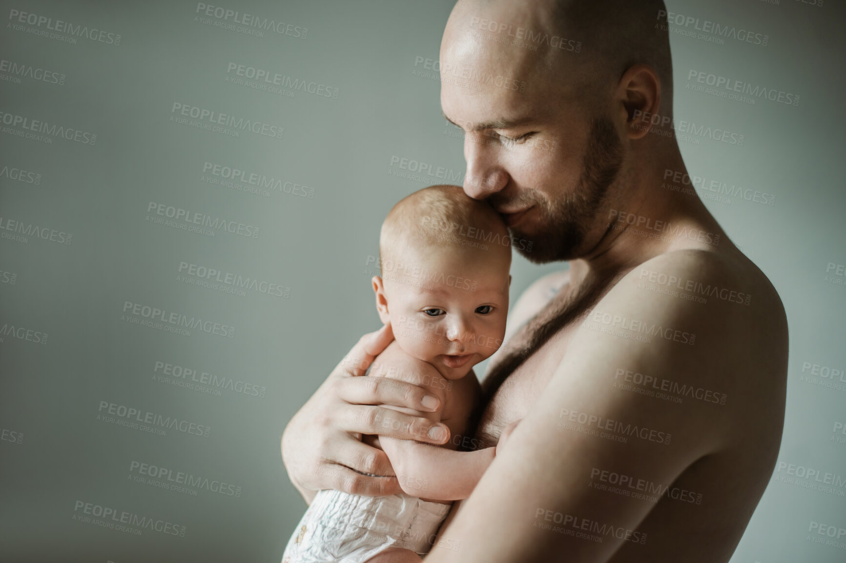 Buy stock photo Family, baby and papa with a man hugging his child in studio on a gray background for tender or gentle love. Babies, parent or children with a father holding his newborn infant while bonding together