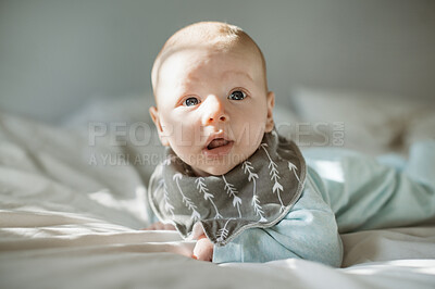 Buy stock photo Adorable, innocent and baby boy on a bed resting, relaxing and playing alone in his nursery. Cute, childcare and face of infant or newborn child from Australia lying in the bedroom of a modern home.