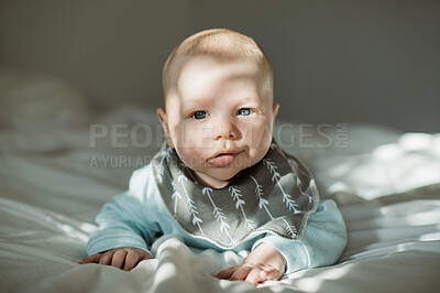 Buy stock photo Cute, innocent and portrait of a baby on a bed resting, relaxing and playing alone in his nursery. Adorable, newborn and face of infant boy child from Australia lying in the bedroom of a modern home.