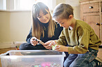 Toys, learning or child development with a mother and son playing in a bedroom of their home together. Education, children and school with a teacher or tutor helping a male kid learn motor skills