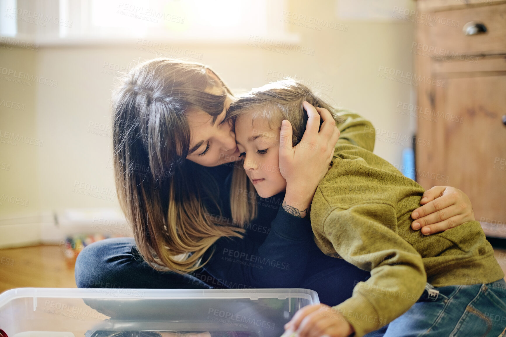 Buy stock photo Love, comfort and mother embracing with her child while playing together in his bedroom with toys. Happy, cute and young woman hugging and bonding with her boy kid with gentle care at family home.