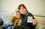 Happy, therapist and a child with an emotion card, showing reaction and feelings in therapy. Together, care and blur of a psychologist with a kid for counseling and working on emotional intelligence