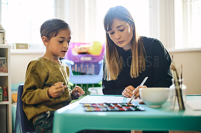 Buy stock photo Painting, education and art with teacher and child in classroom for creative, learning and youth. Teaching, hobby and drawing with woman and young boy for picture, inspiration and artwork lesson