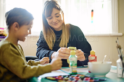 Buy stock photo Education, paint or art with a mother and son in a playroom together for child development or learning. Family, painting or homework with a woman teacher and student boy bonding while being creative