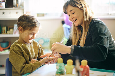 Buy stock photo Art, activity and teacher and student painting hands for learning, education and project. Happy, artist and a woman applying paint to the hand of a child for creativity, class work and hobby