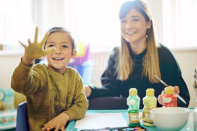 Buy stock photo Mother, happy child and painting hand in home for learning, bonding and care. Boy, art and smile of kid with mama for creative hobby, development and artistic education while enjoying time together.