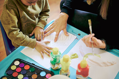 Buy stock photo Hands, painting paper and mother with child for learning, education and bonding. Art, top view and mama teaching kid drawing with color and paint brush, fingerprints and enjoying playing together.