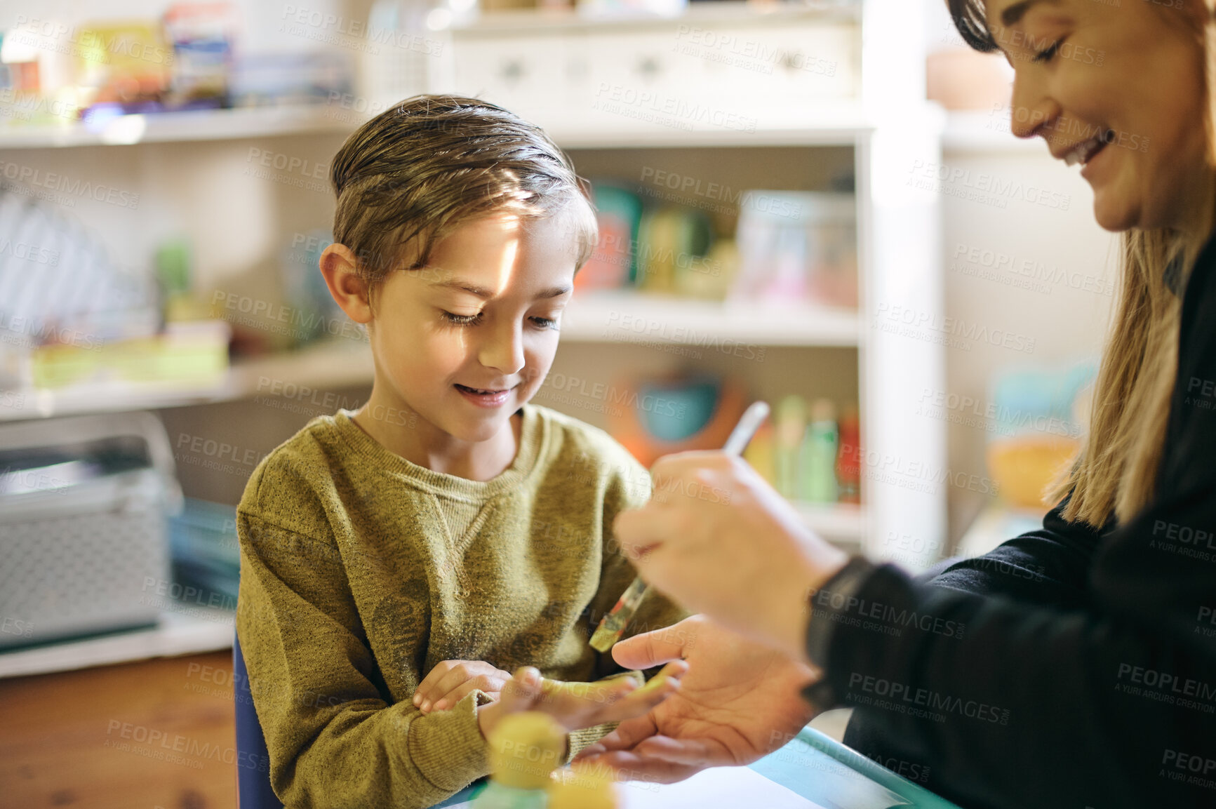 Buy stock photo Art, creative and teacher and child painting hands for learning, education and project. Happy, artist and a woman applying paint to the hand of a student for creativity, class work and hobby