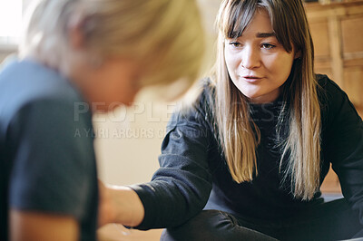 Buy stock photo Therapy, comfort and therapist speaking to a child on autism, adhd or mental health in a clinic. Psychology, healthcare and female kid psychologist talking to a young boy in office at wellness center