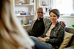 Interracial couple, counseling smile and therapist sofa with psychology conversation and support. Psychologist, consultation and lounge couch with people with happiness and love from marriage