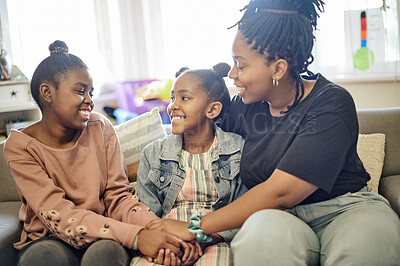 Buy stock photo Happy, relax and smile with mother and daughters on sofa for bonding, free time and weekend. Happiness, affectionate and hug with woman and young girls at home for joyful, carefree and support