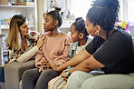 Children, therapy and mental health center for kids talking to a counselor or therapist before adoption in a house or home. Group and woman in discussion with young people for support, care and love