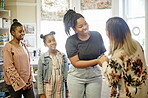 Parent, teacher and kids meeting in classroom at Montessori  school for education, learning and teaching. Child development, mother and educator handshake, conversation and young students in class.