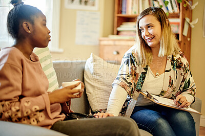 Buy stock photo Clipboard, child and psychologist woman talking, support and help with checklist, evaluation or assessment therapy. Tea, empathy and relax therapist person and african kid in consultation discussion
