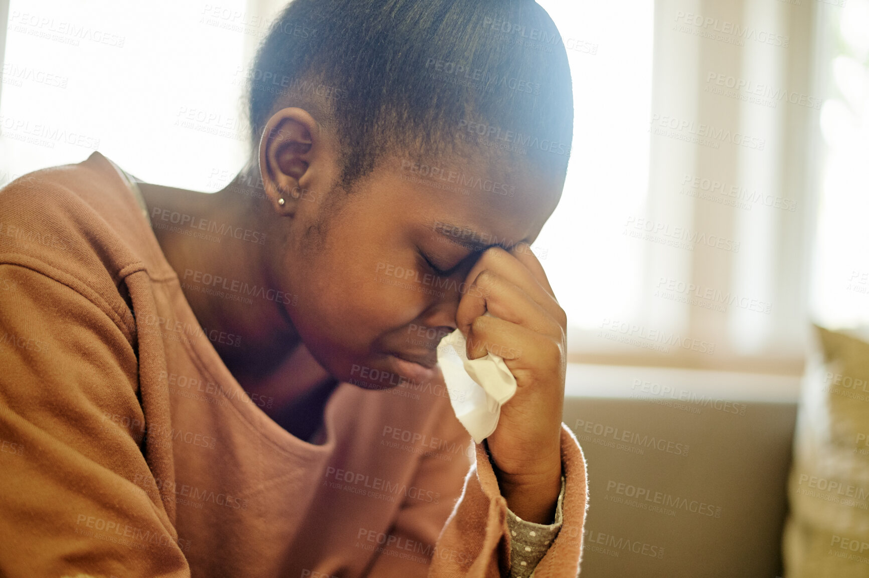 Buy stock photo Sad, crying and black girl with depression in home, anxiety or mental health problem. Depressed, stress and African person, kid or teenager with tissue for tears, bad news or grief, loss or tragedy.