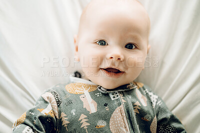 Buy stock photo Happy, cute and portrait of a baby on a bed for playing, relaxing and resting at home. Smile, adorable and face of a newborn child in the bedroom in the morning for rest, comfort and relaxation