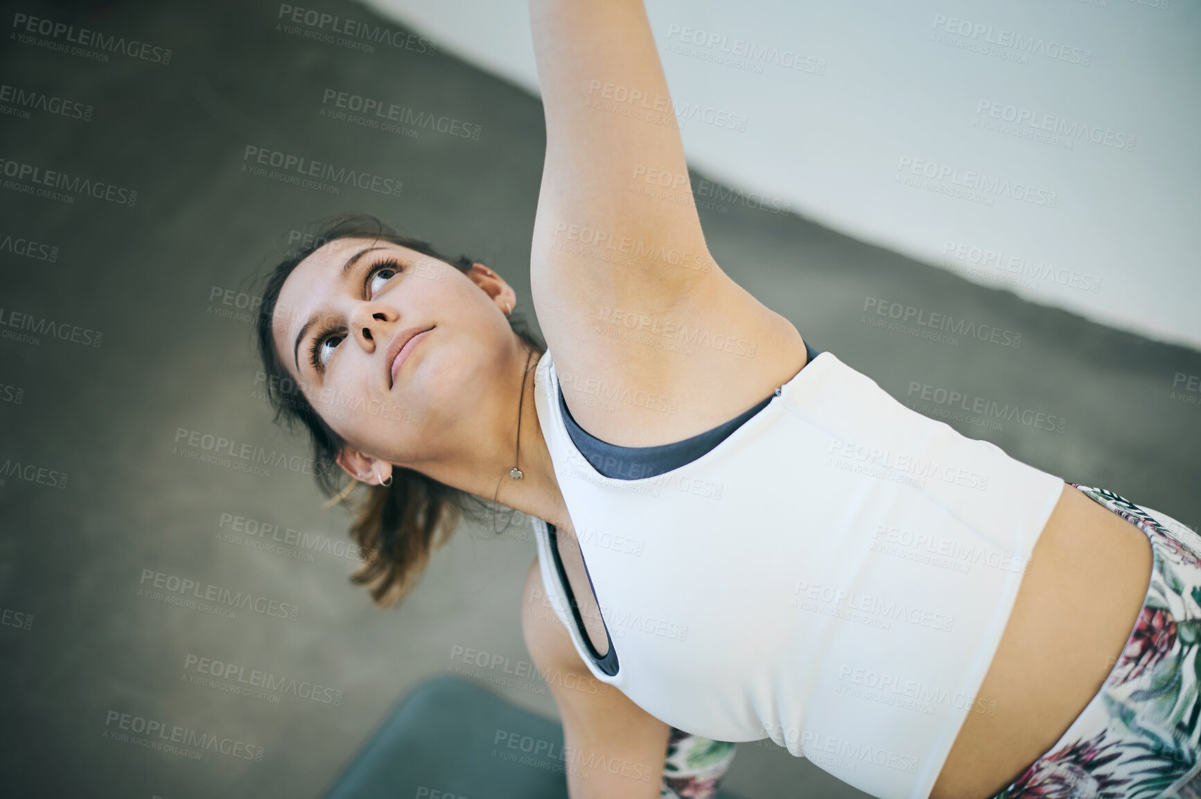 Buy stock photo Yoga, woman and triangle exercise for workout, training and fitness of athlete, pilates and energy from above. Focused female stretching arms for flexible body, wellness and strong sports performance