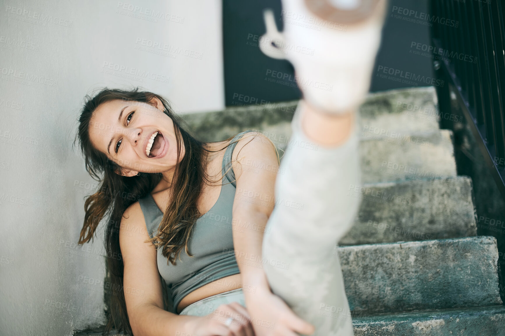Buy stock photo Happy, city and portrait of fitness woman on stairs and relaxing after fun exercise, training and cardio workout with kick. Smile, sports and young playful girl with confidence and kicking by steps