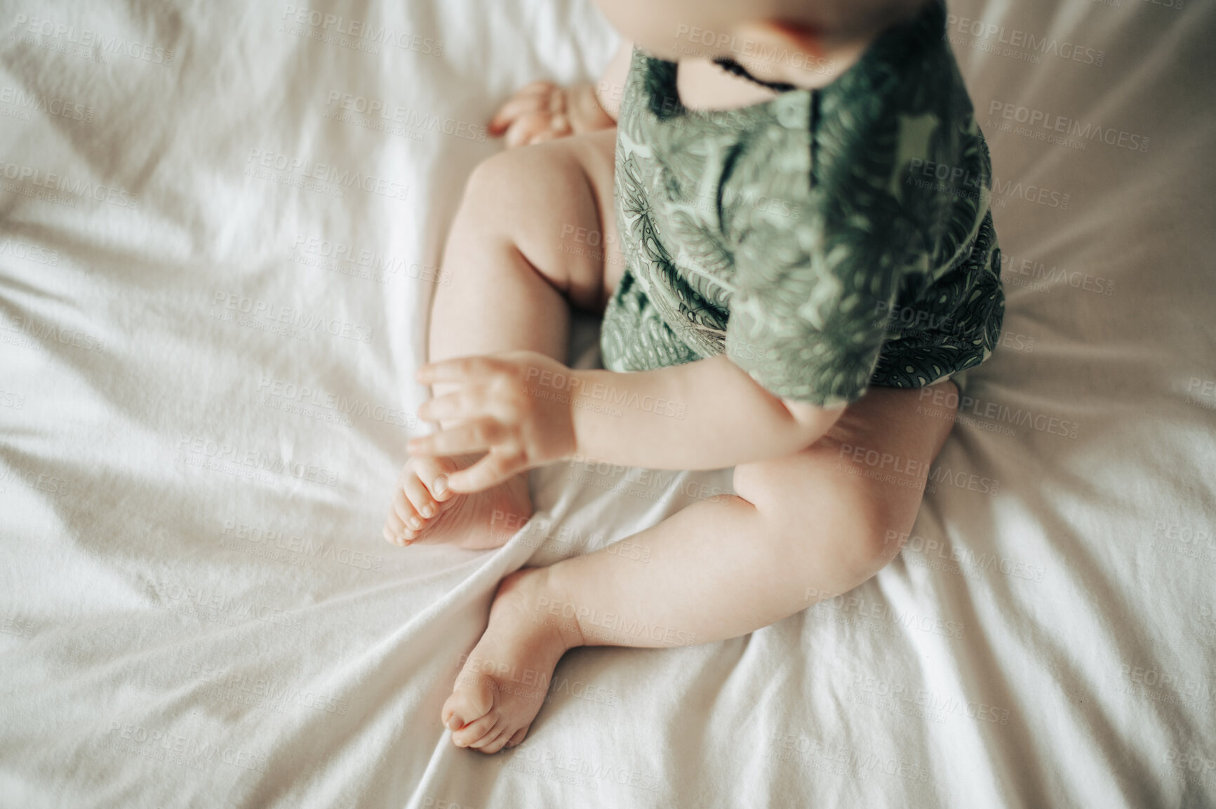 Buy stock photo Baby, infant and newborn relax and playing on a bed in a bedroom and calm in a nursery or room alone in a home or house. Overhead, cute and sitting adorable kid or calm young child barefoot 