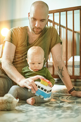 Buy stock photo Man playing with baby on nursery floor, new dad and infant bonding with toys in bedroom at home. Family, love and development, young father and child development, teaching and learning with fun toy.
