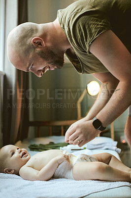 Buy stock photo Baby, bed and diaper with a father changing the nappy of his boy in their home during childcare. Babies, change and cleaning with a responsible dad caring for his newborn infant in the house