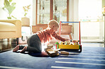 Childhood, learning and a baby with toys for playtime, educational games and play. Kindergarten, young and a playful toddler playing with a toy in a playroom for mental development in a lounge