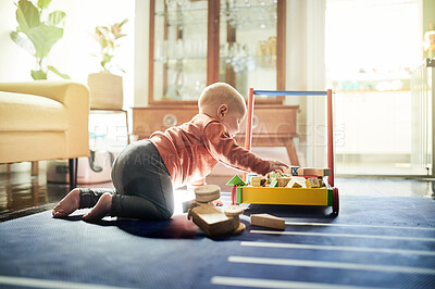 Buy stock photo Childhood, learning and a baby with toys for playtime, educational games and play. Kindergarten, young and a playful toddler playing with a toy in a playroom for mental development in a lounge