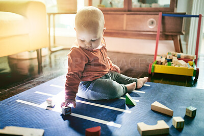 Buy stock photo Education, toys and building blocks with baby on floor of living room for child development, learning and health. Curious, innocence and playing with kid at home for mobility, games and youth