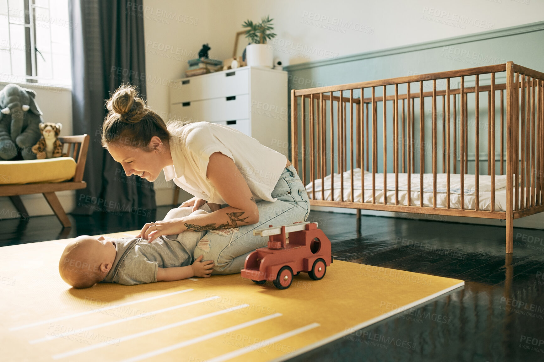 Buy stock photo Laugh, bond and mother and baby playing in nursery, have fun and enjoy relax time together at home. Happy family love, growth and newborn child care of youth kid with mom tickling infant on floor