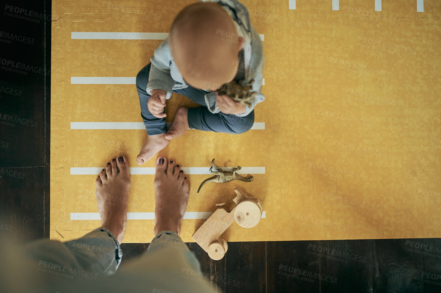 Buy stock photo Playful, toys and top view of a baby and mother on a carpet playing for childhood development. Bonding, fun and closeup of woman or mom feet with a boy infant, child or kid in their family home.